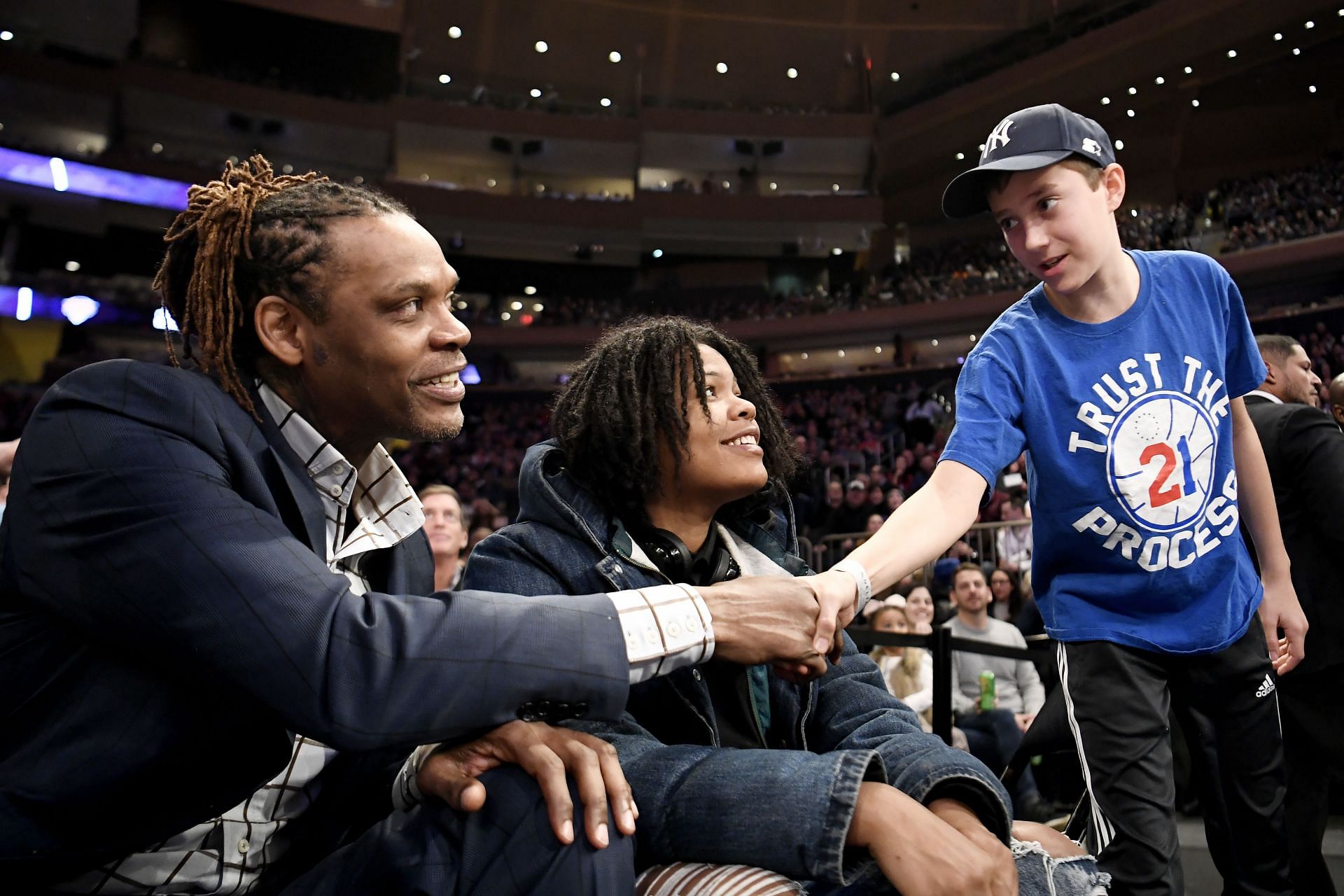 A young fan greets Latrell Sprewell, former Knicks guard